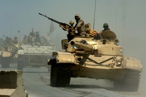 060518-N-6901L-022 (May 18, 2006) Mushahda, Iraq.Iraqi tanks from the Iraqi Army 9th Mechanized Division pass through a highway checkpoint on their way to Forward Operating Base Camp Taji, Iraq..U.S. Navy photo by Photographer's Mate 1st Class Michael Larson. (RELEASED)