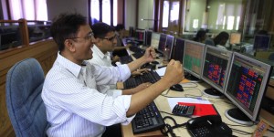 MUMBAI, INDIA - MAY 13: Stock traders rejoice the as Sensex rose to a third consecutive record high at Bombay stock exchange on May 13, 2014 in Mumbai, India. The Sensex hit a record high of 24,068.94, surpassing the psychologically important 24,000 mark for the first time in its history surging after exit polls showed the Bharatiya Janata Party and its allies winning a majority in the elections. (Photo by Anshuman Poyrekar/Hindustan Times via Getty Images)