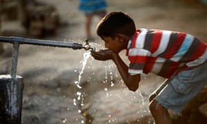 MDG An Indian boy drinks water from a roadside tap in Allahabad, India